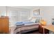 Bedroom with two windows, hardwood floors, and a queen-size metal bed frame at 5351 Bridge St # 41, Tampa, FL 33611
