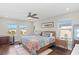 Inviting bedroom with colorful bedding, ceiling fan, and natural light from multiple windows at 5351 Bridge St # 41, Tampa, FL 33611