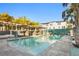 Resort-style community pool with cabanas, stylish seating, and lush tropical landscaping under clear skies at 5351 Bridge St # 41, Tampa, FL 33611