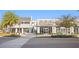 Modern retail center with various storefronts, palm trees, and pedestrian-friendly sidewalks under blue skies at 5351 Bridge St # 41, Tampa, FL 33611