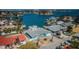 Aerial view of waterfront home with a dock, lush landscaping, and seawall at 629 59Th Ave, St Pete Beach, FL 33706