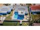 Aerial view of a house with a pool, hot tub and dock on a waterway at 629 59Th Ave, St Pete Beach, FL 33706