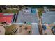 Aerial view of cozy single-story home featuring vibrant blue exterior with driveway and backyard at 629 59Th Ave, St Pete Beach, FL 33706
