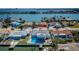 Waterfront home with a private pool, dock, and boat lift, providing access to the open bay and nearby islands at 629 59Th Ave, St Pete Beach, FL 33706