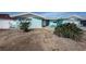 Light-blue house with a gravel yard and an inviting outdoor seating area in the front at 629 59Th Ave, St Pete Beach, FL 33706