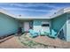 Charming home exterior with light-blue facade and an inviting outdoor seating area at 629 59Th Ave, St Pete Beach, FL 33706