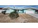 Light-blue home with a gravel yard, featuring front yard foliage and a well-maintained lawn at 629 59Th Ave, St Pete Beach, FL 33706