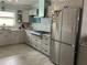 Spacious kitchen featuring stainless steel appliances, a stone backsplash and gray cabinets and countertops at 629 59Th Ave, St Pete Beach, FL 33706