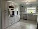 Renovated kitchen featuring stainless steel appliances, granite counters, and custom cabinetry at 629 59Th Ave, St Pete Beach, FL 33706