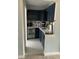 A cozy kitchenette with dark blue cabinets, white countertops, wine cooler, and patterned tile flooring at 629 59Th Ave, St Pete Beach, FL 33706