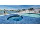 Waterfront pool and spa area with blue tile, white fencing, and dock access at 629 59Th Ave, St Pete Beach, FL 33706