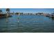 Waterfront view with dock extending into calm waters, surrounded by lush scenery and homes at 629 59Th Ave, St Pete Beach, FL 33706
