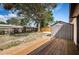 Spacious backyard featuring a wooden deck, storage shed, and mature trees at 6445 109Th N Ave, Pinellas Park, FL 33782