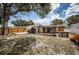 Large, partially-fenced backyard with storage shed, wood deck, and playset at 6445 109Th N Ave, Pinellas Park, FL 33782
