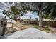 Expansive backyard with a deck, hot tub, playset, shed, and mature tree at 6445 109Th N Ave, Pinellas Park, FL 33782