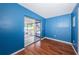 Bright bedroom with hardwood floors and sliding door to the screened-in porch at 6445 109Th N Ave, Pinellas Park, FL 33782