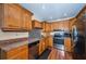 Modern kitchen featuring stainless steel appliances, ample wooden cabinetry and countertop space, offering a functional design at 6445 109Th N Ave, Pinellas Park, FL 33782