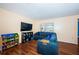 Bright living room featuring a comfortable sectional sofa, sleek wood floors, and a window, creating a cozy space at 6445 109Th N Ave, Pinellas Park, FL 33782
