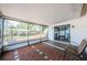 Covered and screened porch with brick flooring and view of the fenced-in backyard at 6445 109Th N Ave, Pinellas Park, FL 33782