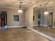This living room offers tiled floors, a partial view to the kitchen, and a mirrored wall at 6815 Dali Ave # F101, Land O Lakes, FL 34637