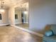 Open living area with tile floors, a large mirror, and stylish pendant lighting at 6815 Dali Ave # F101, Land O Lakes, FL 34637