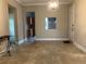 Inviting living room featuring light-colored walls, tile flooring, and an adjacent kitchen view at 6815 Dali Ave # F101, Land O Lakes, FL 34637