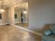 Bright living room featuring neutral walls, pendant lighting, and a large mirror at 6815 Dali Ave # F101, Land O Lakes, FL 34637