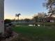 Peaceful pond view surrounded by lush greenery and a walking path in the community at 6815 Dali Ave # F101, Land O Lakes, FL 34637