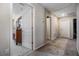 Hallway features neutral walls, carpet floors and doors leading to bedrooms, bathrooms, and laundry at 7010 Wiseman Run Dr, Sun City Center, FL 33573