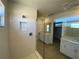 Modern bathroom featuring a glass enclosed shower, double vanities, and neutral tiling at 7105 119Th E Ct, Palmetto, FL 34221