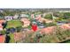 Overhead view of homes with red tile roofs with community pool nearby at 7200 Ulmerton Rd # B4, Largo, FL 33771