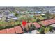 Aerial shot of condos in a community near a pond, pool, and tennis courts at 7200 Ulmerton Rd # B4, Largo, FL 33771
