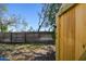 A wooden gate leads to the backyard with mature trees and lush greenery at 7200 Ulmerton Rd # B4, Largo, FL 33771