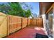 Private fenced-in backyard patio with a concrete surface, tropical plants, and sliding glass door at 7200 Ulmerton Rd # B4, Largo, FL 33771