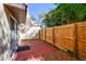Enclosed backyard patio featuring a privacy fence, concrete flooring, and lush tropical landscaping at 7200 Ulmerton Rd # B4, Largo, FL 33771