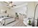 Loft style bedroom with ceiling fan and a cozy seating area at 7200 Ulmerton Rd # B4, Largo, FL 33771
