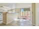 Bright kitchen with a breakfast bar and sliding glass door leading to outdoor patio at 7200 Ulmerton Rd # B4, Largo, FL 33771