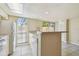 Kitchen with modern appliances, breakfast bar, and sliding glass door to an outdoor area at 7200 Ulmerton Rd # B4, Largo, FL 33771