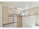 Kitchen with white cabinets, appliances, and breakfast bar offering a clean aesthetic at 7200 Ulmerton Rd # B4, Largo, FL 33771