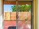 View through sliding glass doors to fenced outdoor space and lush tropical foliage at 7200 Ulmerton Rd # B4, Largo, FL 33771