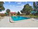 A fenced-in community pool area with a large pool and ample seating at 7200 Ulmerton Rd # B4, Largo, FL 33771