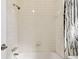 A tiled shower and bathtub with a shower curtain and chrome fixtures at 7200 Ulmerton Rd # B4, Largo, FL 33771
