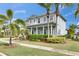 Charming two-story home with a welcoming front porch and lush landscaping at 735 Manns Harbor Dr, Apollo Beach, FL 33572