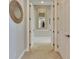 Hallway with white trim and neutral-colored walls and floors at 735 Manns Harbor Dr, Apollo Beach, FL 33572