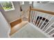 Carpeted staircase leads to a lower level with hardwood floors at 735 Manns Harbor Dr, Apollo Beach, FL 33572