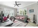 Comfortable bedroom featuring a daybed, ceiling fan, and bright natural light from shuttered windows at 868 27Th N Ave, St Petersburg, FL 33704