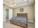 Bright bedroom with a tray ceiling and an ensuite bathroom with a glass enclosed shower at 9818 Stillchase St, Tampa, FL 33625