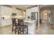 Bright kitchen island with seating, stainless steel appliances, and white cabinets, designed for modern living at 9818 Stillchase St, Tampa, FL 33625