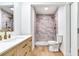 Bright bathroom with a step-in shower, and a vanity with brass colored hardware at 303 Suzette Dr, Brandon, FL 33511