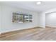 Spacious bedroom with light wood flooring, white walls and trim, and a large window with neighborhood views at 303 Suzette Dr, Brandon, FL 33511